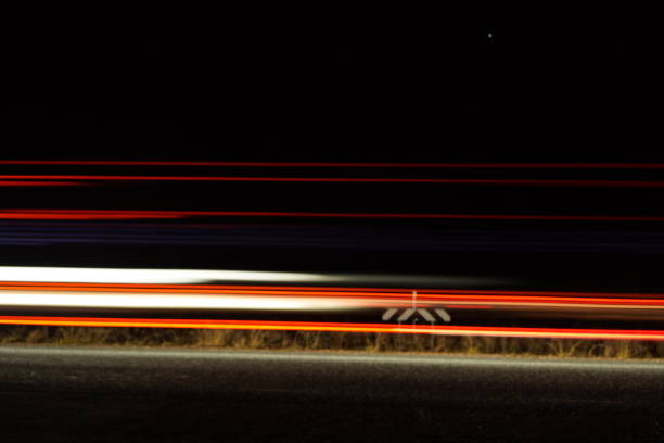 Slow shutter photo of lights from a car on a highway