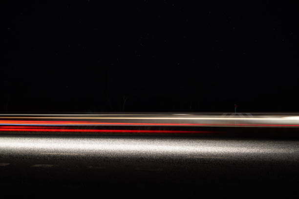 Slow shutter photo of lights from a car on a highway Slow shutter photo of lights from a car on a highway long shutter speed stock pictures, royalty-free photos & images