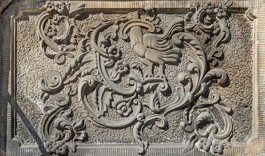 stone slab with a pattern of a laurel wreath, a symbol of glory and memory. beautiful floral carved pattern on a stone surface