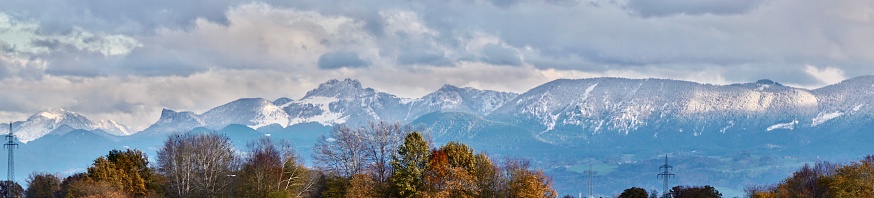 A wide overview of the Bavarian Alps. Autumn Bavarian Alps with snow-covered peaks of mountains.