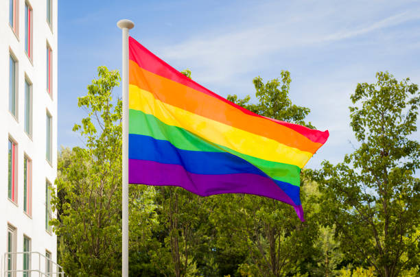 istock Gay pride flag (rainbow flag) flying on flagpole, Bournemouth UK 1418380718