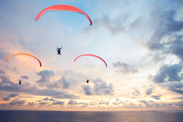 istock Three paragliders against the sky over with beautiful sunset 1418385090