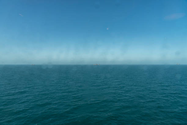 Oil rig in the distance off Kent, England, Europe.  This is late afternoon.
