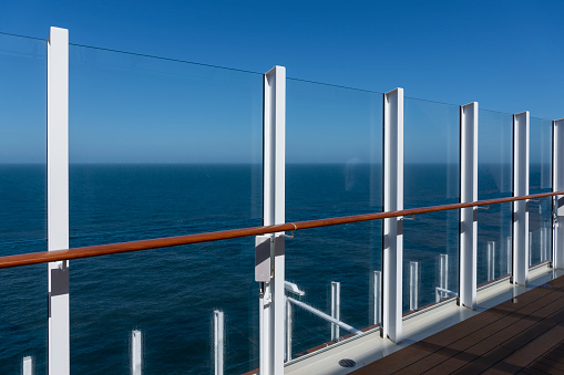 Safety railing of luxury cruise ship. Calm sea, blue sky. Cruise ship sailing on the Aegean Sea in summer. No people.