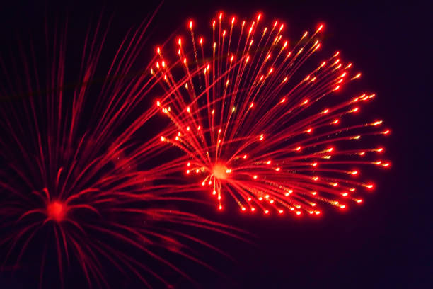 Bright, beautiful red fireworks in the night sky. stock photo