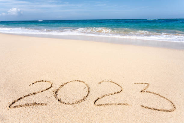 istock Happy New Year 2023, lettering on the beach with wave 1418391857