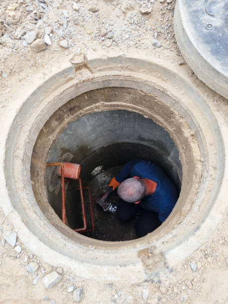 istock Man Working on Old Clay Ceramic Sewer Line Pipes 1418393330