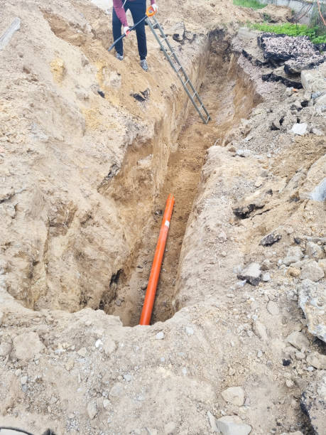 istock Man Working on Old Clay Ceramic Sewer Line Pipes 1418393352