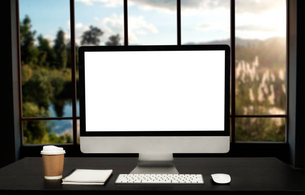 istock Workspace computer putting on wood working desk and surrounded by coffee cup, clipboard, potted plant, stack of tablet, and keyboard  Orderly office. workspace concept. 1418406498