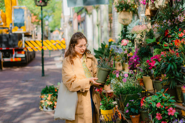 istock Woman picking plants  from flower shop 1418406826