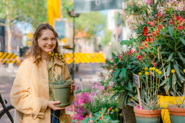 istock Woman picking plants  from flower shop 1418406867