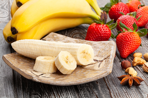 Variety of healthy smoothie bowls with ingredients on the kitchen counter. Top view of different types of fruit smoothie bowls served on table.