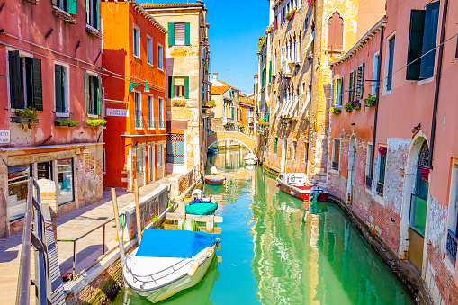 Sunny colorful street with water canal in Venice city, Italy travel photo