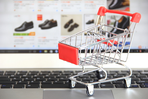 Online shopping, shopping cart and laptop computer