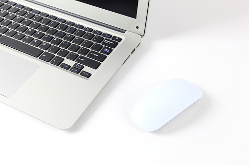 Laptop computer and computer mouse on white background