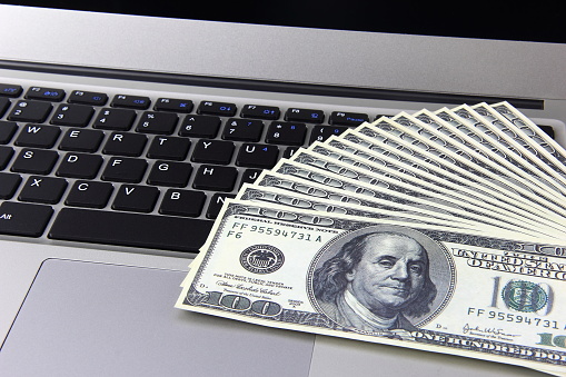 Money on laptop computer