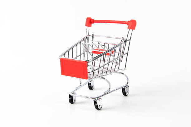 Little cute girl playing with toy shopping cart