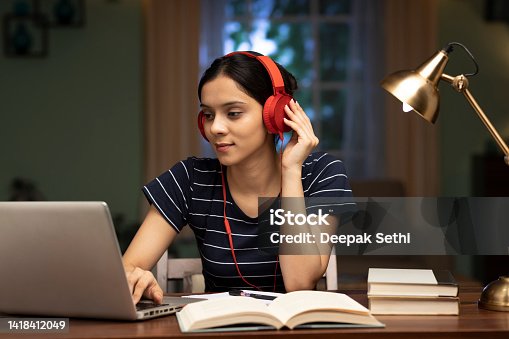 istock Young woman listening music at home, stock photo 1418412049