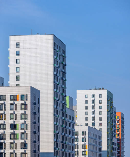 istock Monolithic white residential apartment buildings district on blue sky 1418412327
