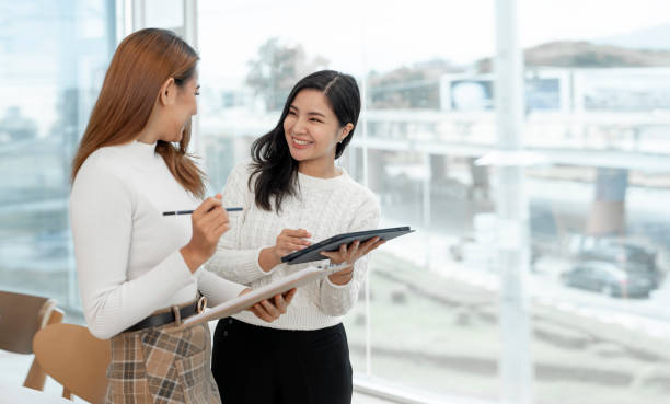 istock Two Young Asian businesswoman discuss with new startup project Idea presentation, analyze planning and financial statistics and investment market at office. 1418413446