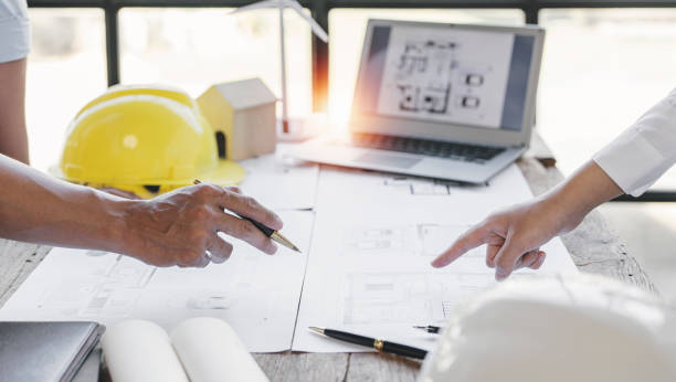 istock engineer meeting for architectural project. working with partner and blueprint on workplace vintage tone. 1418413759