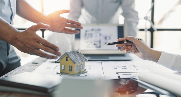 istock engineer meeting for architectural project. working with partner and blueprint on workplace vintage tone. 1418414480