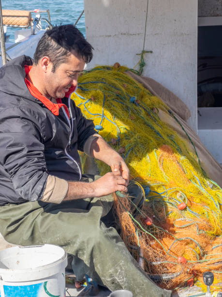 istock Happy smiling fisherman at work on a sunny day 1418415560