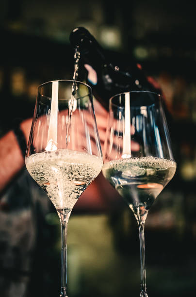 istock bartender pouring white wine into a glass in cafe or bar 1418415792