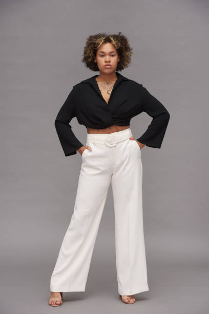 istock Young confident multi-ethnic woman in black cropped top and white pants 1418423656