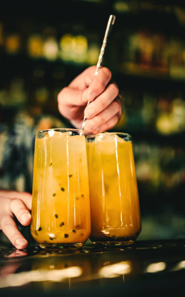 istock bartender making cocktail with passion fruit in a nightclub bar 1418424031