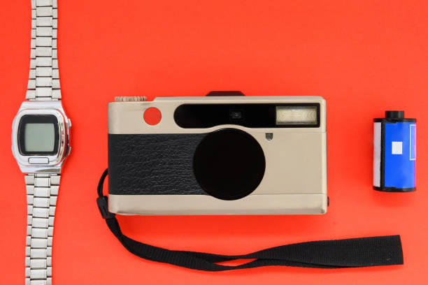 istock classic film camera and electronic clock on a red background close-up 1418424414