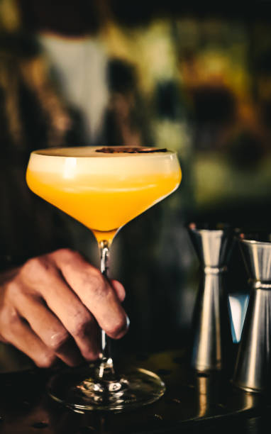 istock man hand bartender holding cocktail in glass on the bar counter 1418432407