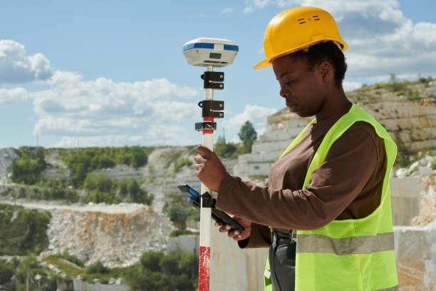 istock Young serious black woman in workwear adjusting technical equipment 1418436640