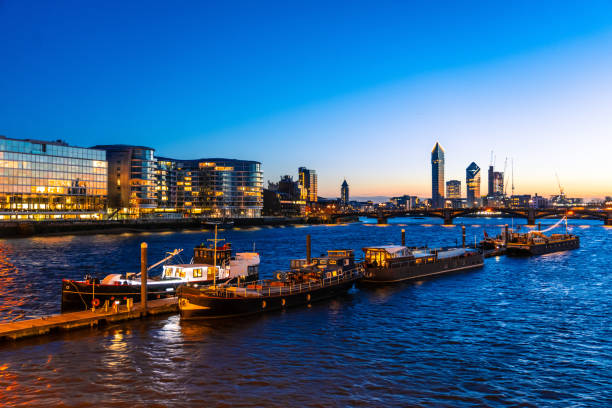 Boats along the river thames at night