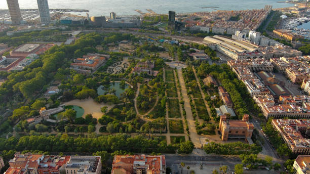 Aerial view of Barcelona City Skyline with Park de la Ciutadella - thirty hectare large park close to always crowded historic center of Barcelona The Parc de la Ciutadella is very idyllic and probably the greenest oasis in the megacity of Barcelona. It invites you to relax, to rebound and to go for long walks, as well as for a picnic. parc de la ciutadella stock pictures, royalty-free photos & images