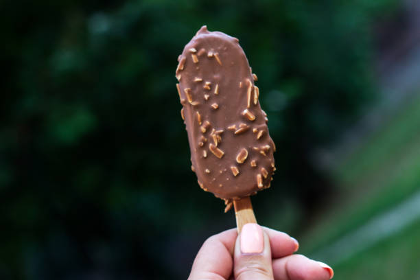 istock Woman holding chocolate ice cream 1418447207