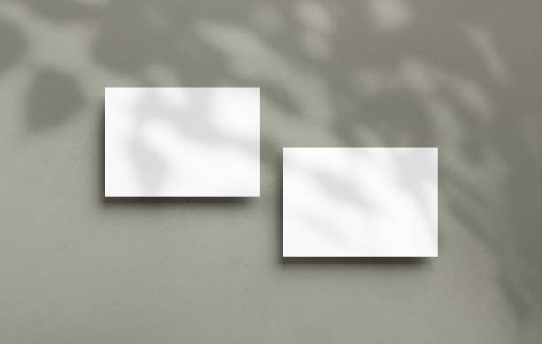istock Postcard mockup empty double sided template with overlay shadow on a textured background. Blank paper card for design 1418452524