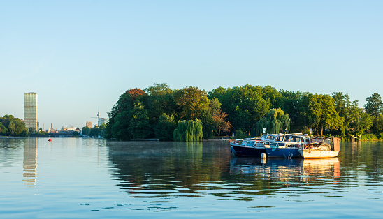 Boats are anchored in a bay on Rummelsburg lake in Berlin.