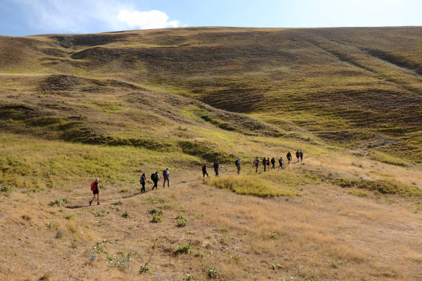istock Hikers in a row climbing in the apennines 1418457913