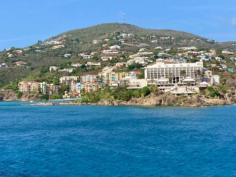 Marigot, Collectivity of Saint Martin, French Caribbean: Marina Port Royal harbormaster building - in the background restaurants, offices and shops along Rue du President Kennedy and hills covered in tropical vegetation.