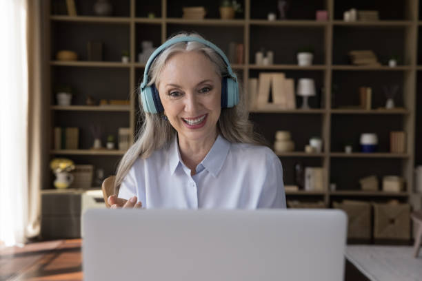 istock Happy pretty mature 60s woman talking on video call 1418459607