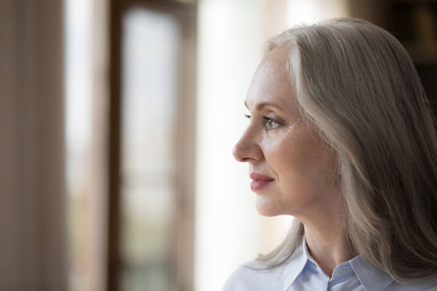 istock Serious lonely senior lady looking away in deep sad thoughts, 1418459654