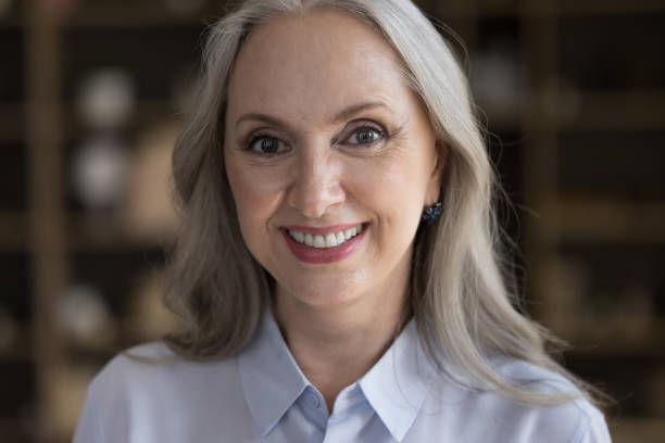 istock Happy beautiful senior lady looking at camera with toothy smile 1418459657