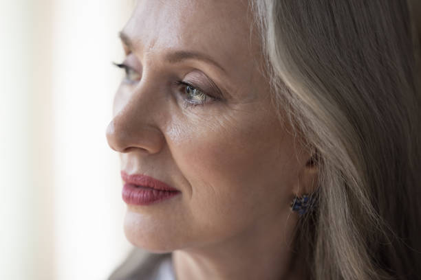 istock Thoughtful senior grey haired woman looking away in deep thought 1418459659