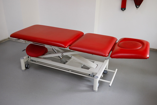 Red couch in the office of a physiotherapist or rehabilitation doctor