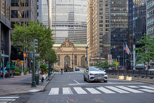 Manhattan, New York, NY, USA - July 9th 2022:  View up Park Avenue toward the Grand Central Railroad Terminal and the MetLife building with a zebra crossing and traffic light in front