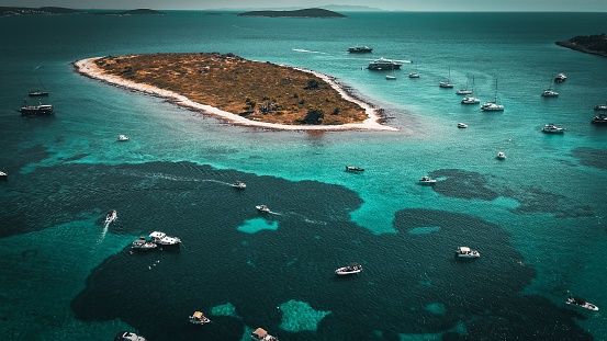 A beautiful island and boats on the sea, aerial shot