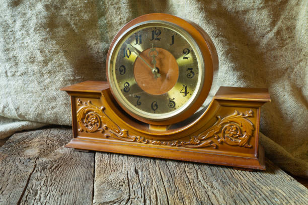istock Vintage clock on a wooden table close-up 1418465155