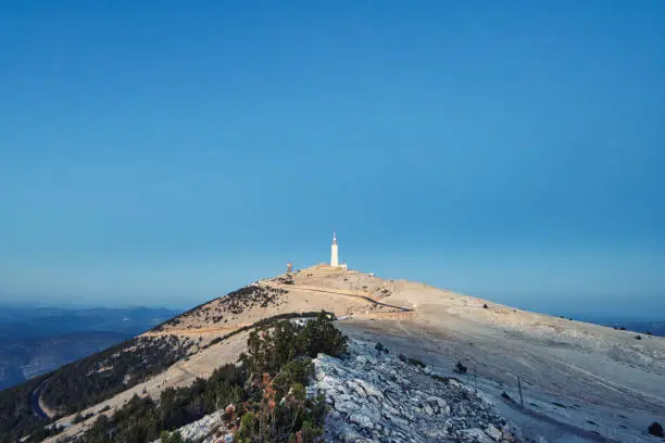 Mont-Ventoux, France - July 27, 2022. Panoramic view from the top of Mont-Ventoux, giant of Provence during sunset. Its astronomical observatory and its famous white pebbles are visible.