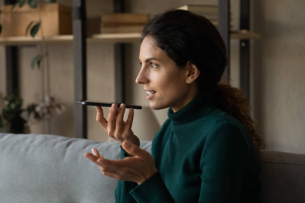 istock Joyful young hispanic woman sending audio message. 1418467547